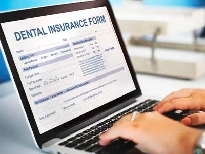 person filling out a dental insurance form